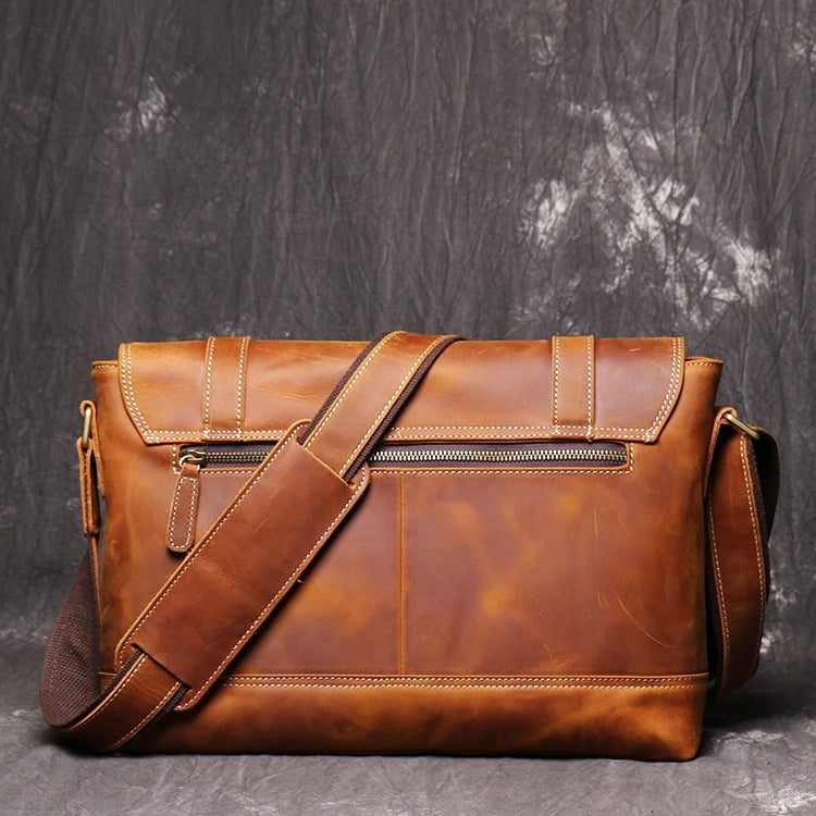 Back view of brown leather messenger bag showing back pocket and zipper