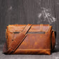 Back view of brown leather messenger bag showing back pocket and zipper