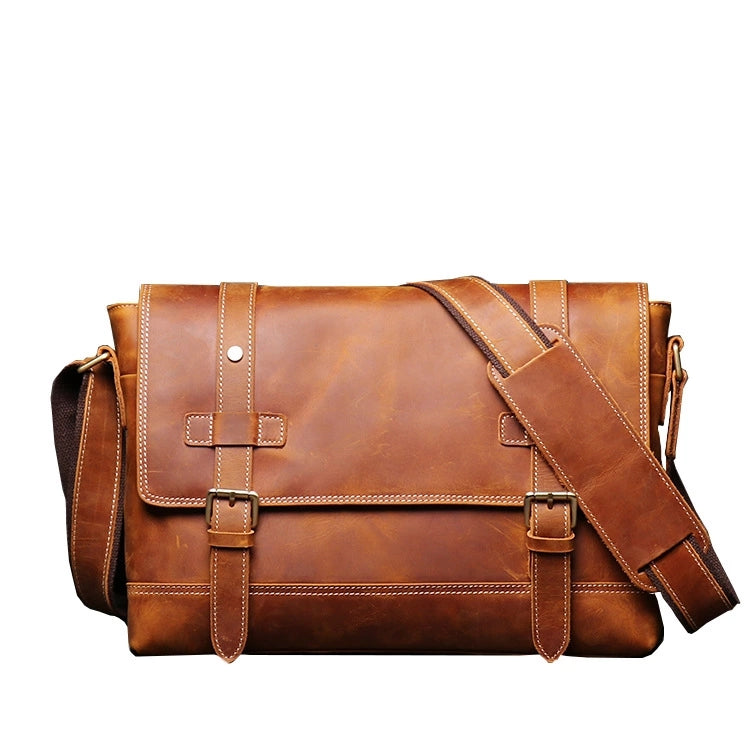 Front view of brown leather messenger bag showing stitching detail and belt straps