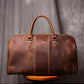 Back view of brown leather duffel bag showing stitching detail and pattern