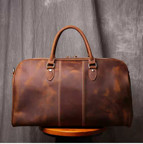 Back view of brown leather duffel bag showing stitching detail and pattern