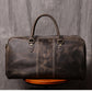 Back view of dark coffee color leather duffel bag showing stitching detail and pattern