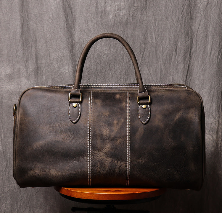 Back view of dark coffee color leather duffel bag showing stitching detail and pattern