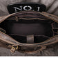 Top view of dark coffee color leather duffel bag showing open zipper and inside details