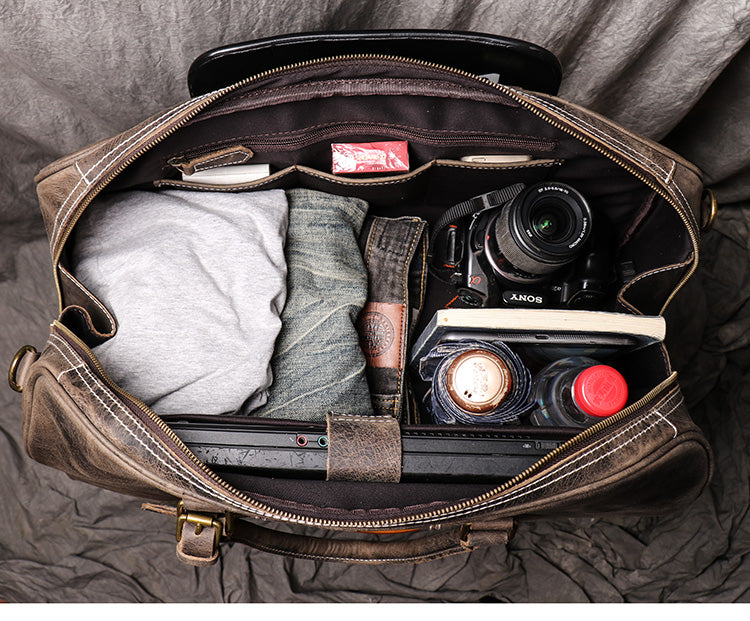 Top view of dark coffee color leather duffel bag showing open zipper and storage capacity